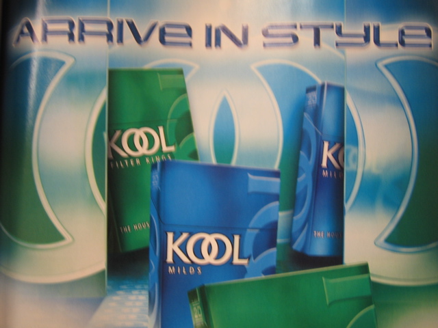 Arrive in Style poster, blue and green, sort of trippy design with Kool cigarette packs. Decidedly uncool.
