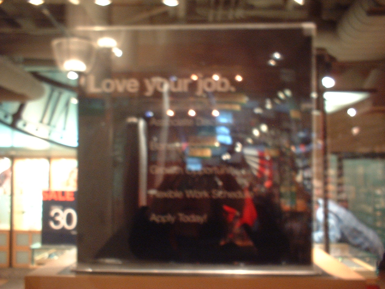 A very blurry sign that says 'Love Your Job.'