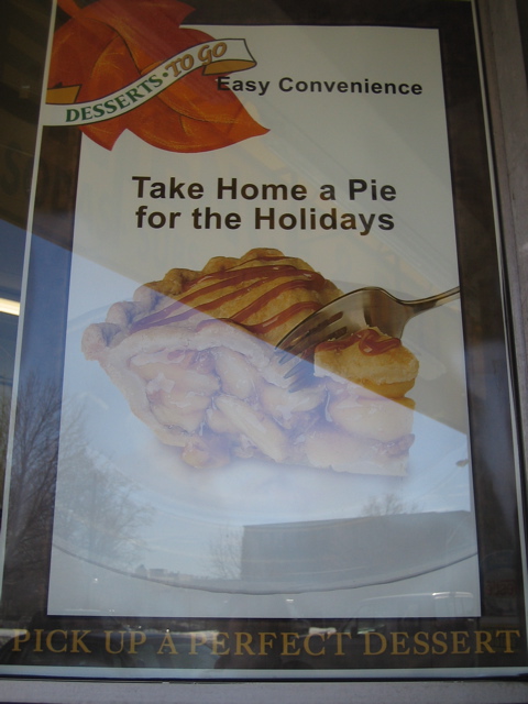 A sign that is behind glass, but appears to have a frame. Could be in the window of a cafe or restaurant - a bit hard to tell.