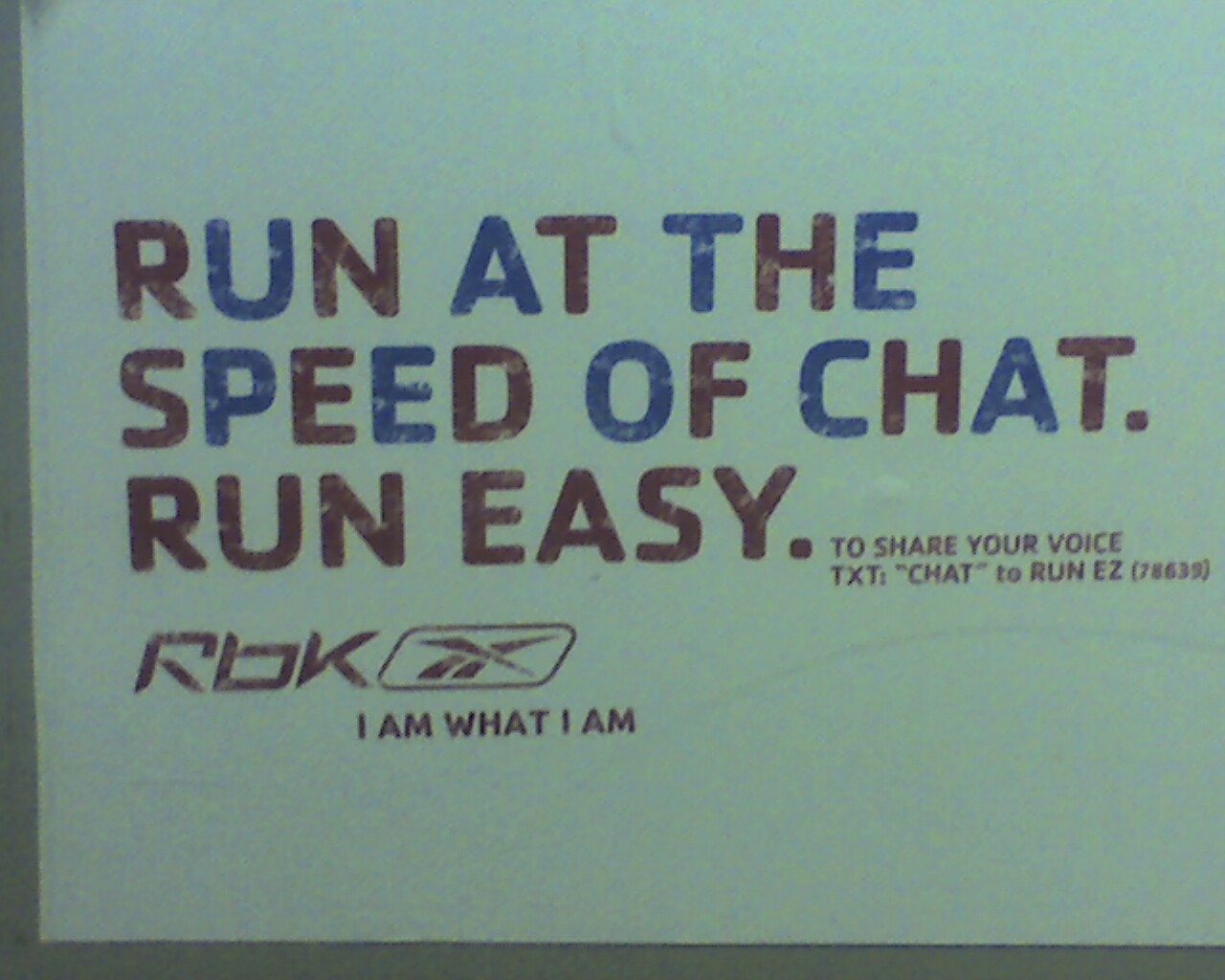 A sign with a light green background and the words, `Run at the speed of chat. Run easy.', written on it.