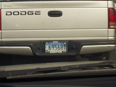An image of a dodge van with a very blurry license plate, that appears to say 'Treasure the Chesapeake' on it.
